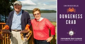 Two people holding Dungeness Crab.