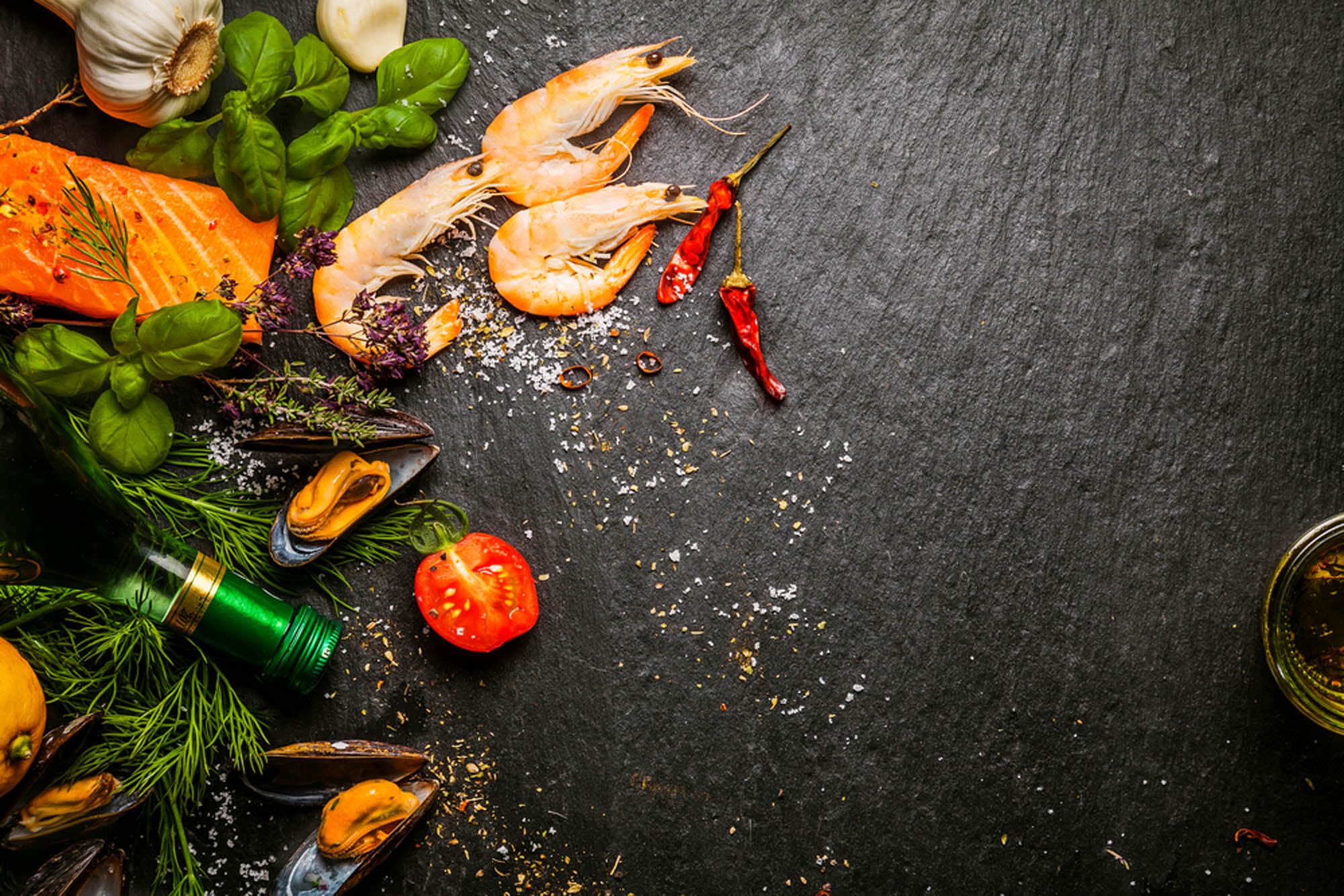 Assortment of fresh food items on a black surface.