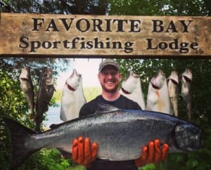 Photo of Man Holding a Giant King Salmon. Salmon Fishing in Alaska at Its Finest