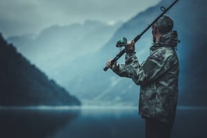 An angler casts while fishing in Alaska at the famed Elfin Cove.