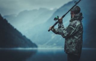 An angler casts while fishing in Alaska at the famed Elfin Cove.