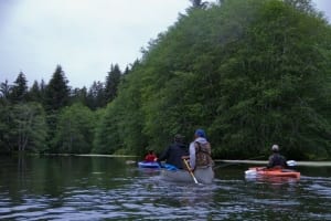 A group of canoers navigate to their next location during a family vacation in Alaska.