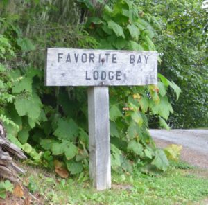 A sign for Favorite Bay lodge along a less traveled road.