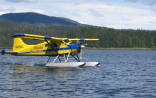 A floatplane sits idle on the water in preparation for another Alaska adventure tour at Favorite Bay Lodge.