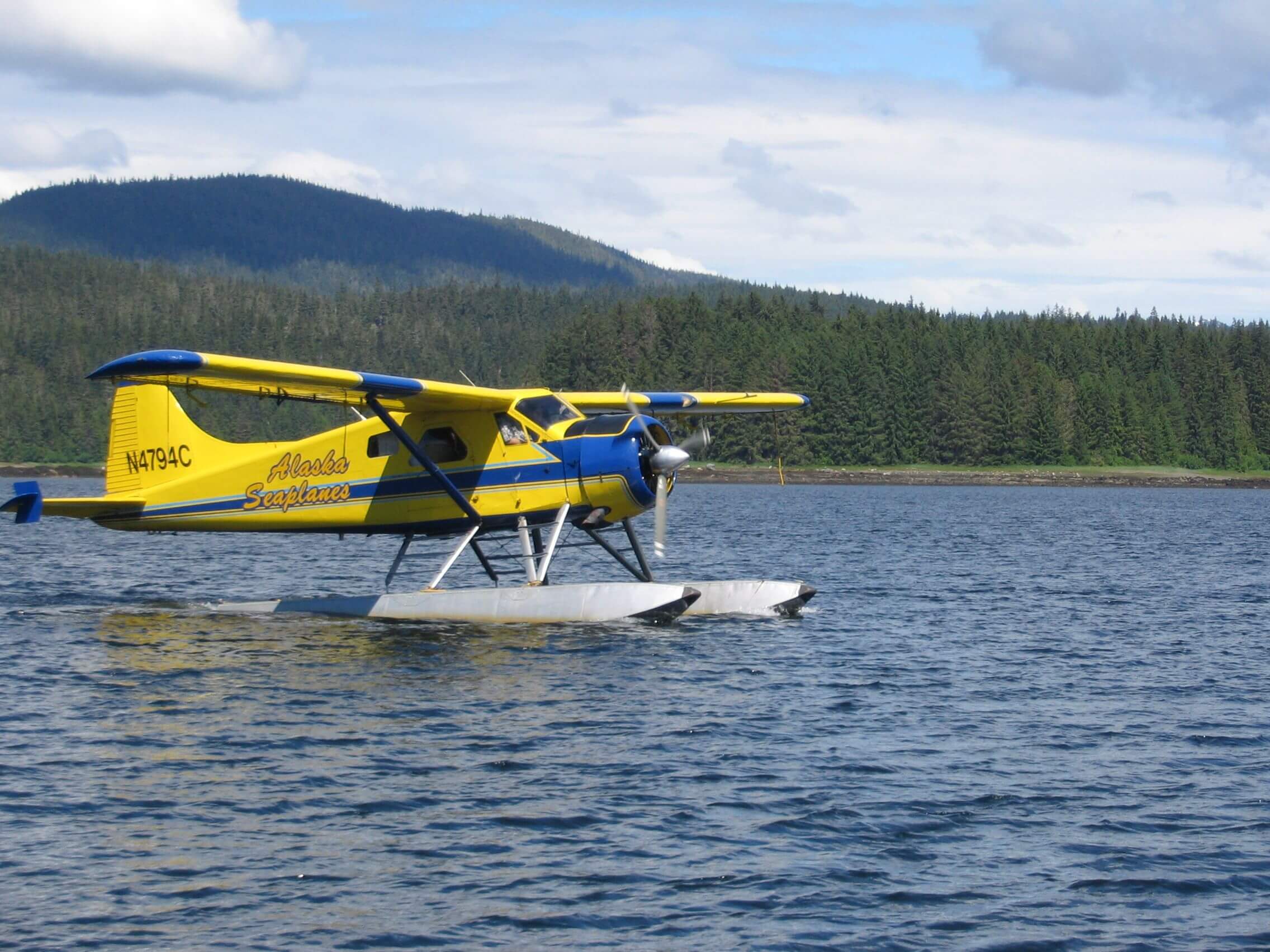 A floatplane sits idle on the water in preparation for another Alaska adventure tour at Favorite Bay Lodge.