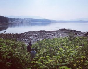 A vacationers hike to shore on a beautiful Alaskan morning near Favorite Bay Lodge.