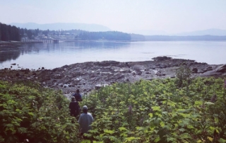 A vacationers hike to shore on a beautiful Alaskan morning near Favorite Bay Lodge.