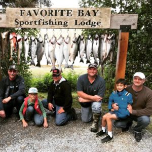 A family of anglers pose for their Alaska family vacation at Favorite Bay Lodge.
