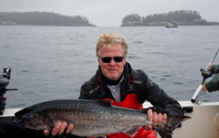 Alaska Fishing Lodge: An avid angler shows off his catch aboard an Alaska fishing charter.