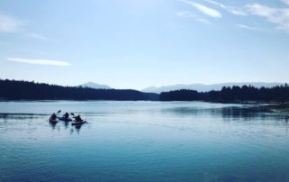 2024 Alaska Vacation Packages: A beautiful view of kayakers exploring an inlet in Southeast Alaska.